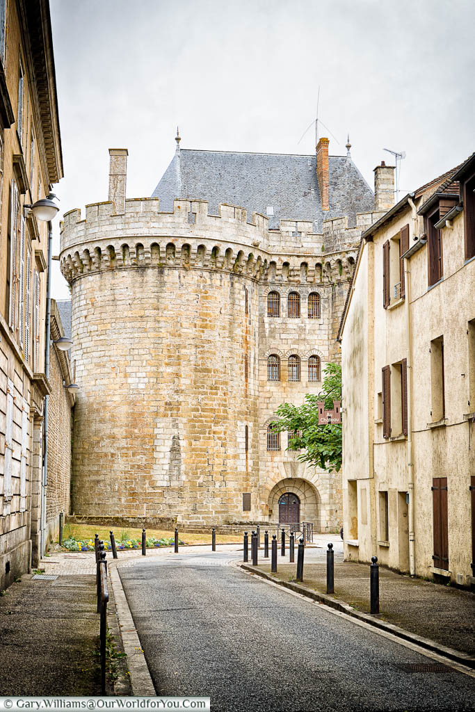 The street view looking towords impressive stone towers of the entrance to 'Le Château des Ducs' in Alençon.