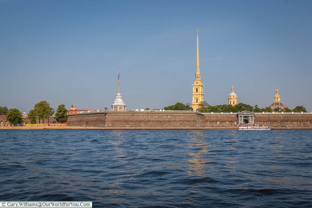 The golden spire of Saint Peter's and Saint Paul's Cathedral from behind the Fortress walls, St Petersburg, Russia