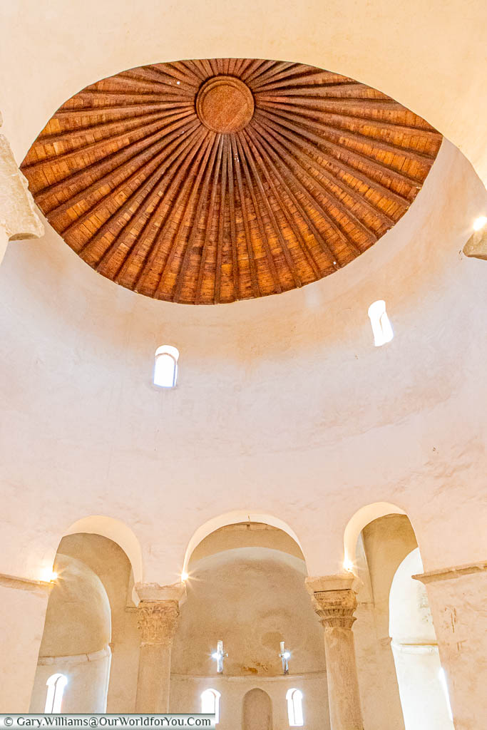 The beautifully light interior of St Donatus Church in Zadar, contrasted against the wooden interior of its dome.