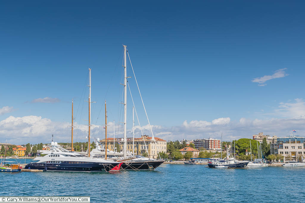 Larger boats moored up in the waters around Zadar on a bright day