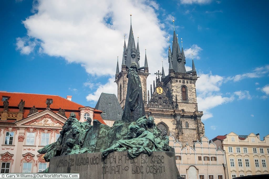 The Jan Hus Memorial in the centre of the old town square of Prague in front of the twin spires of the Church of Our Lady before Týn