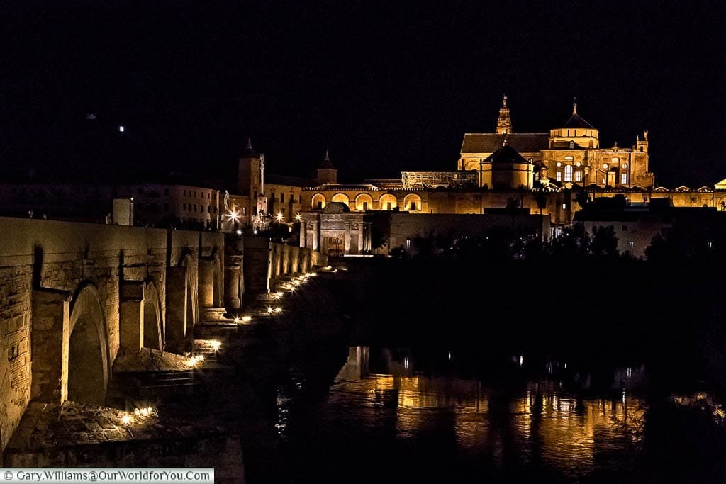 The view across the Roman Bridge of Corbada at night to the Mosque–Cathedral on the hilltop beyond