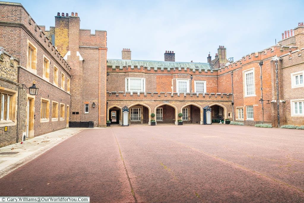 The empty open space of Friary Court surrounded on 3 sides by wings of St James’s Palace