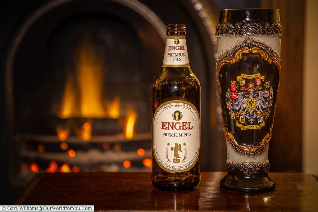 A bottle of German Beer and our German stein, from cuckcooclocks.com, in front of our roaring fireplace.
