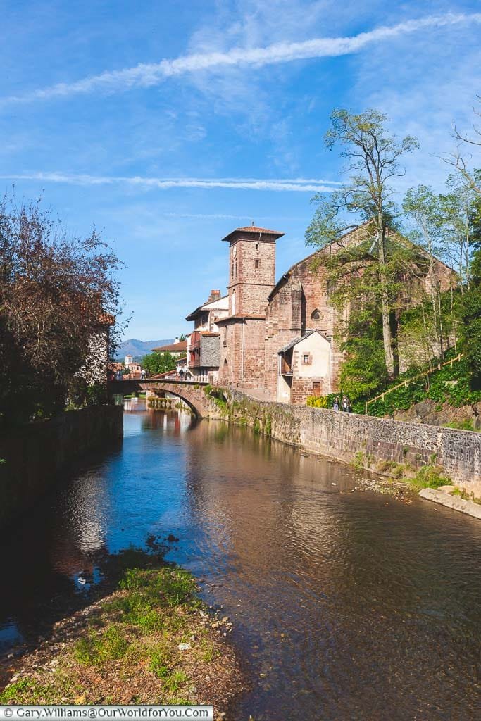 The view of the River Nive towards the Porte Notre-Dame in Saint-Jean-Pied-de-Port in the Pyrénées-Atlantiques region of France