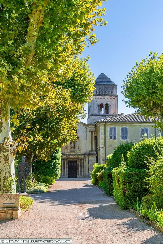 The gravel, tree-lined path to the stone Monastery of Saint-Paul de Mausole in Saint-Rémy-de-Provence, France