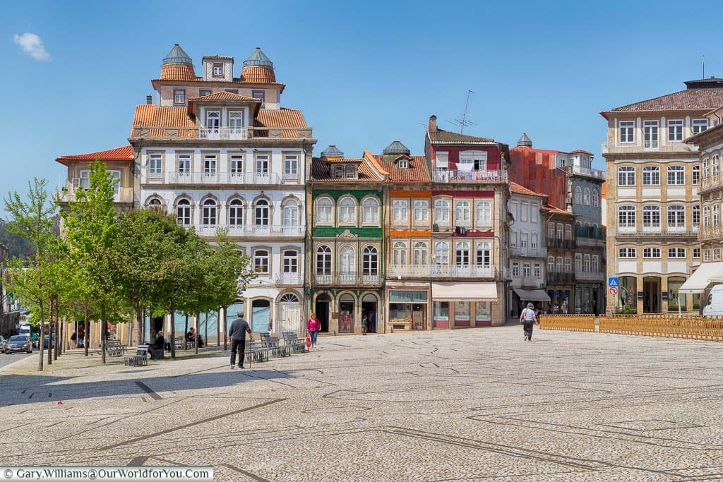 A large open Largo do Toural tilled square, lined with 19th-century buildings, in Guimarães, Portugal