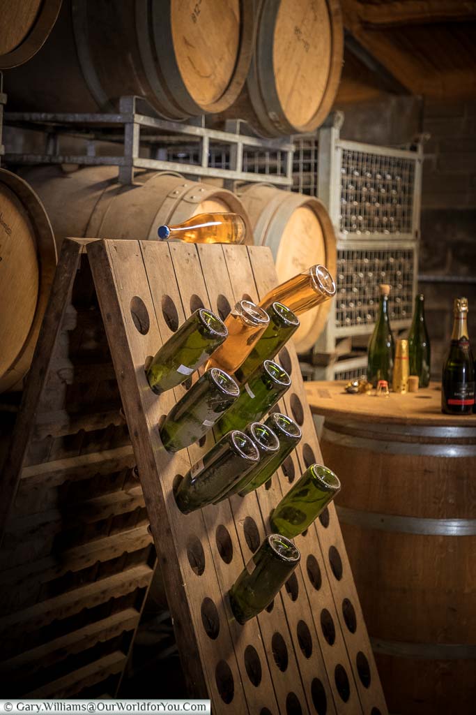 A riddling rack, a wooden A-frame, designed to hold wine bottles angled upside down to persuade the sediment to travel towards the neck of the bottle.