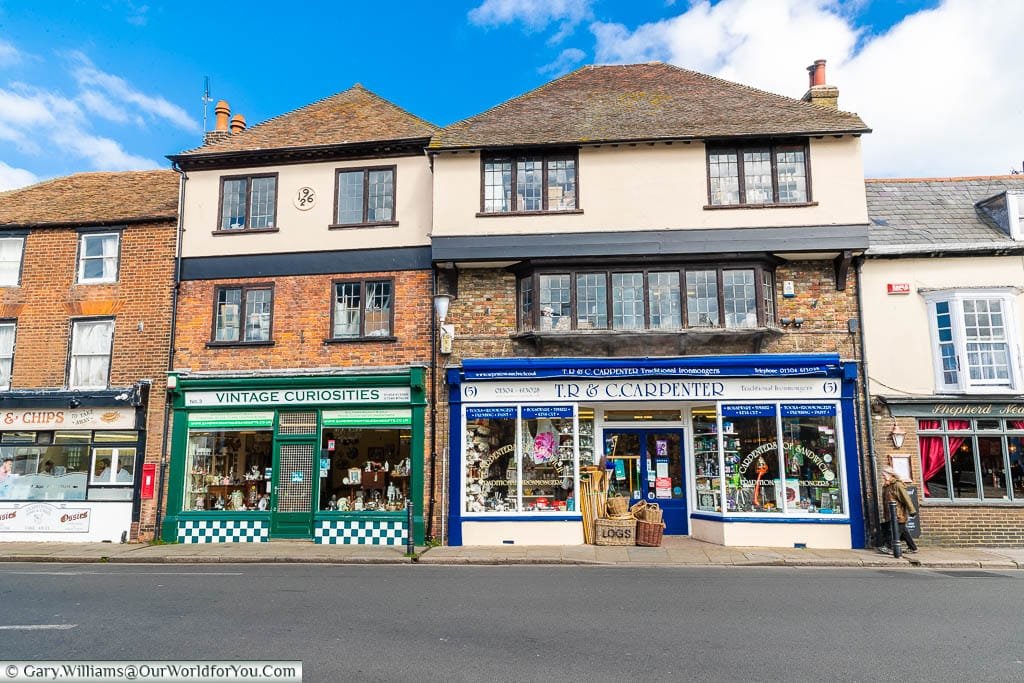 Traditional shops set in historic 16th-century buildings on New Street in the centre of Sandwich, Kent