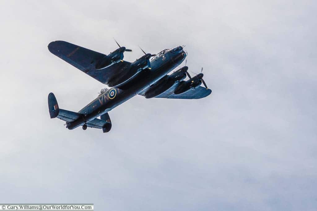 A close-up shot of a Lancaster bomber flying over the River Thames in preparation for the Henley Royal Regatta