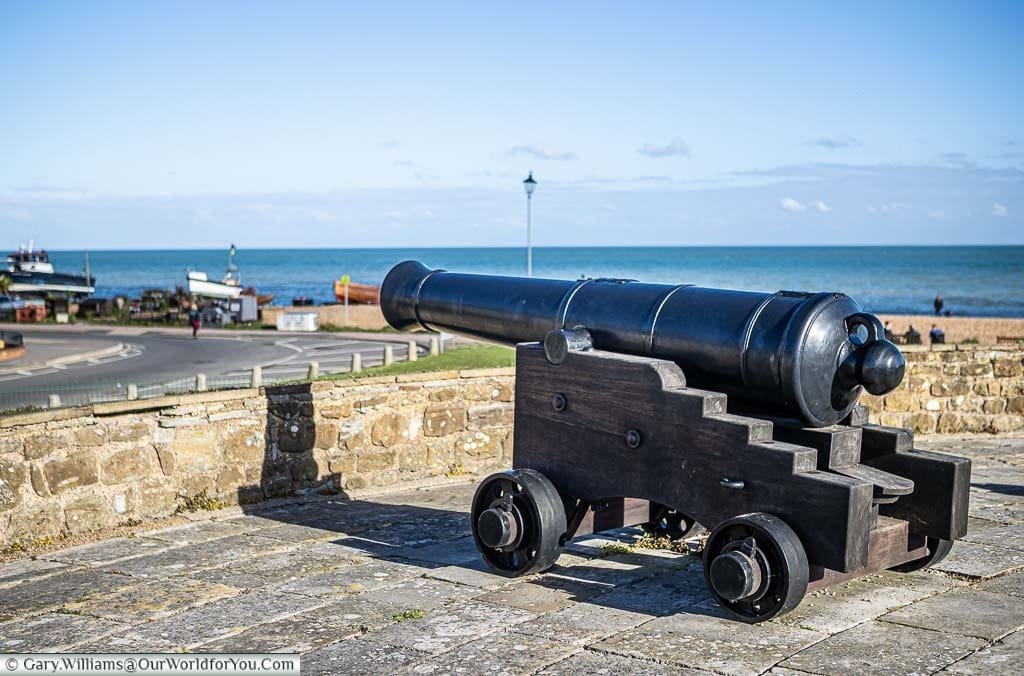 A side profile of an 18th/19th-century cast-iron cannon on a wooden carriage on the walls of Deal Castle