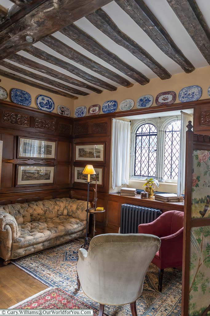 A sofa and chairs in the corner of the Billiard Room of Ightham Mote