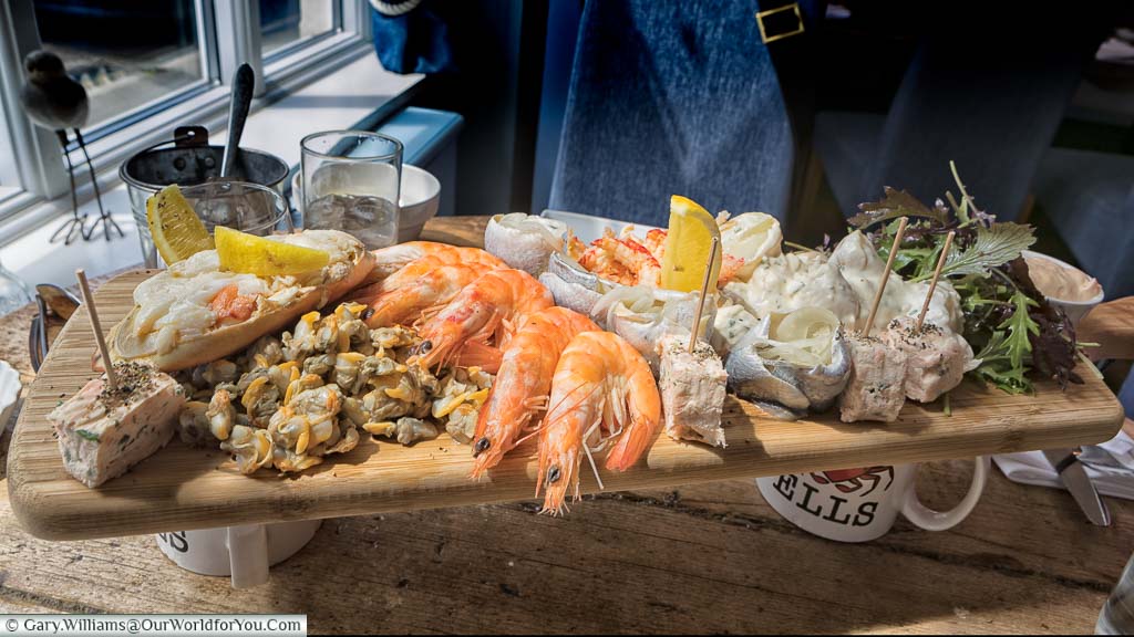 A seafood platter for two served on a wooden board at the Wells Crab House in Wells-next-the-Sea, Norfolk
