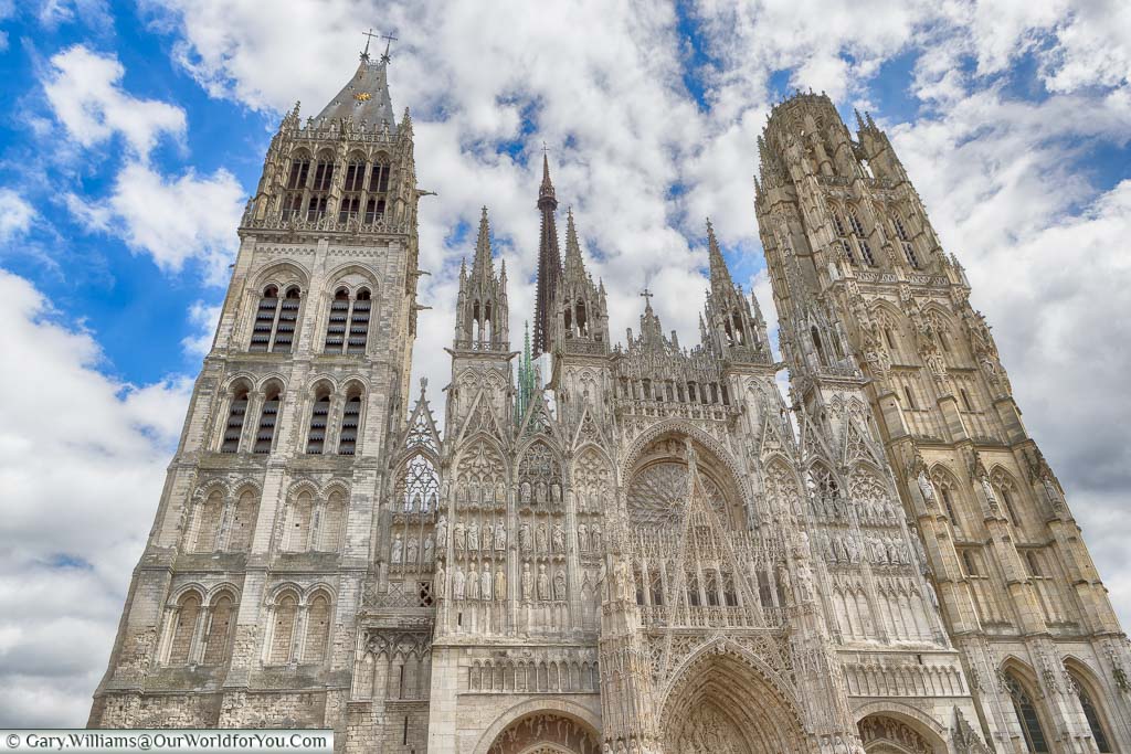 Looking up at the twin stone towers either side of the entrance to Rouen Cathedral, one of the most impressive in all Normandy,