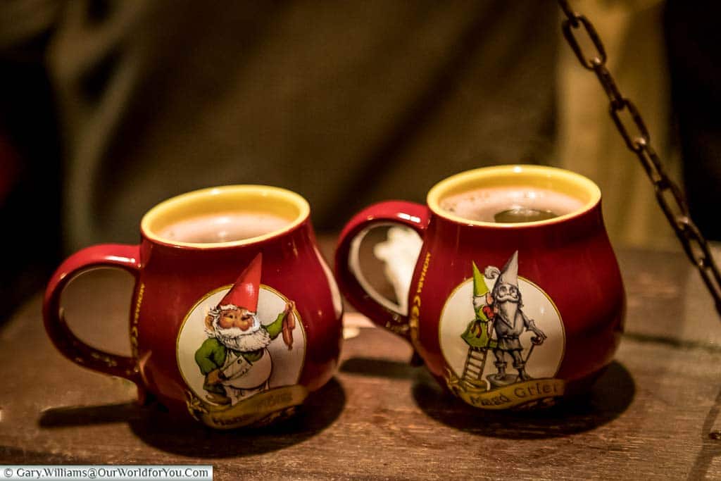 Two of the detailed gluhwein mugs, depicting a different trade, from Cologne's 'Elf Market'.