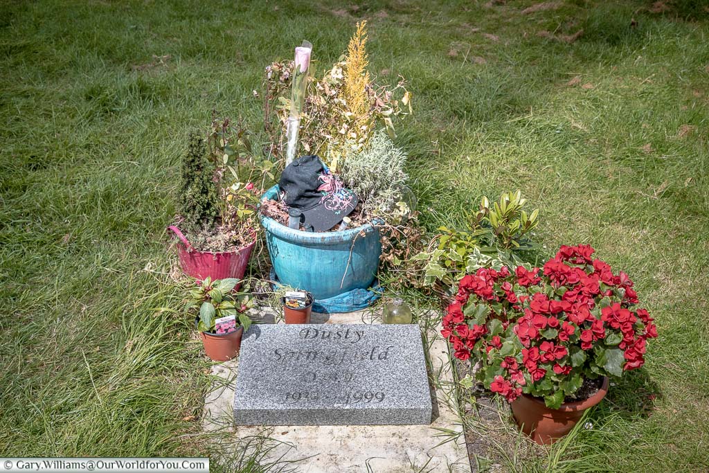 The simple grave, decorated with flowers & pot plants, of Dusty Springfield in St Mary’s Church graveyard