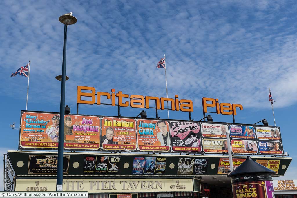 Advertising hoardings, displaying the acts scheduled to appear at the end of the Britannia Pier's theatre, Great Yarmouth
