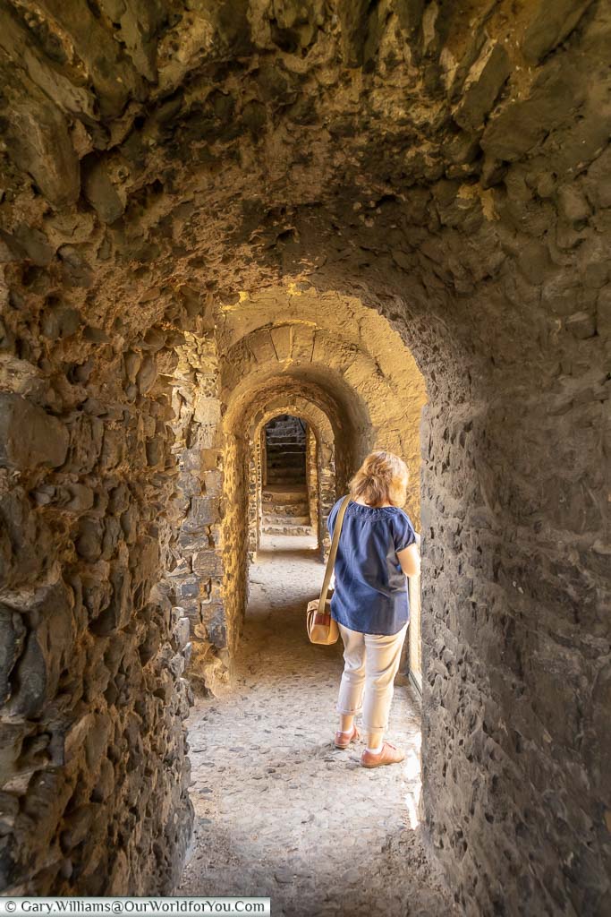 Janis with her back to us in one of the narrow stone corridors in Rochester castle