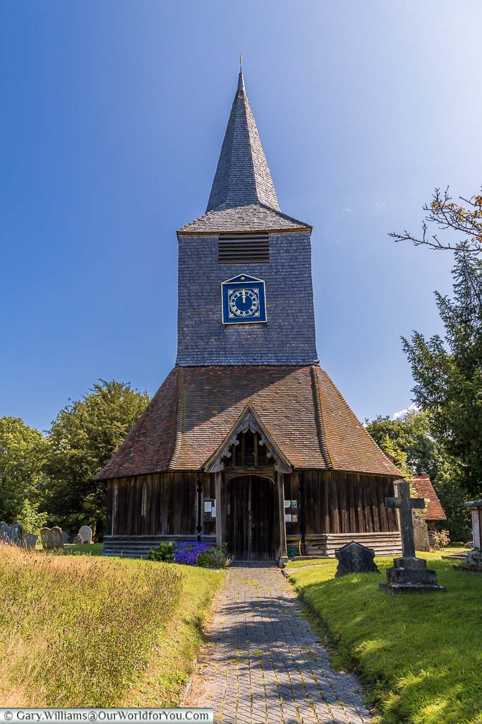 A pathway leading to the historic Church of Saint Mary's with its timbered tower in the village of High Halden, Kent