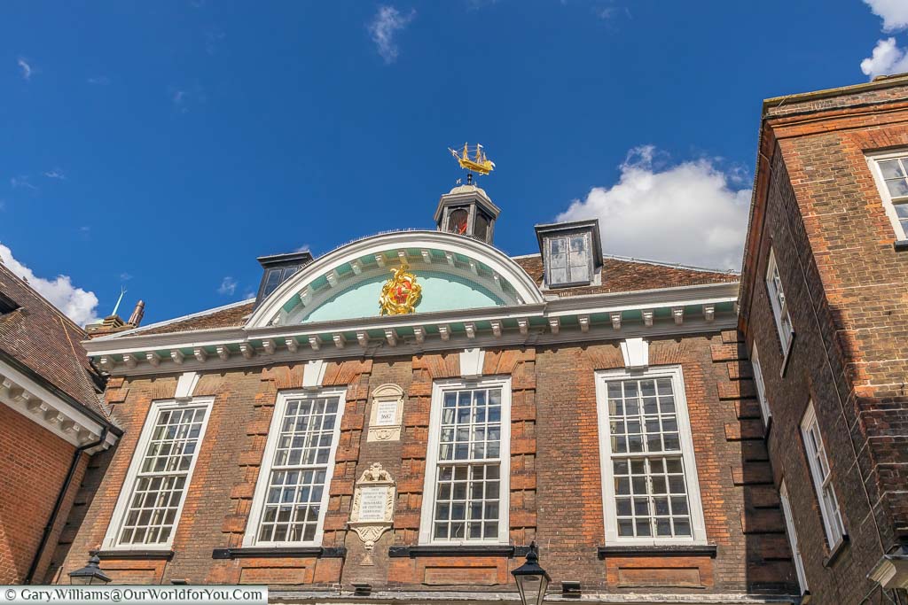 Rochester's Guildhall museum in a red brick building dating from the 17th century with a goldcrest and a golden weathervane in the shape of a galleon.