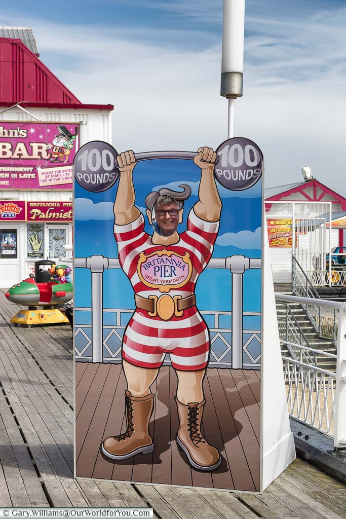 Gary posing through a strongman cutout on the Britannia Pier, Great Yarmouth