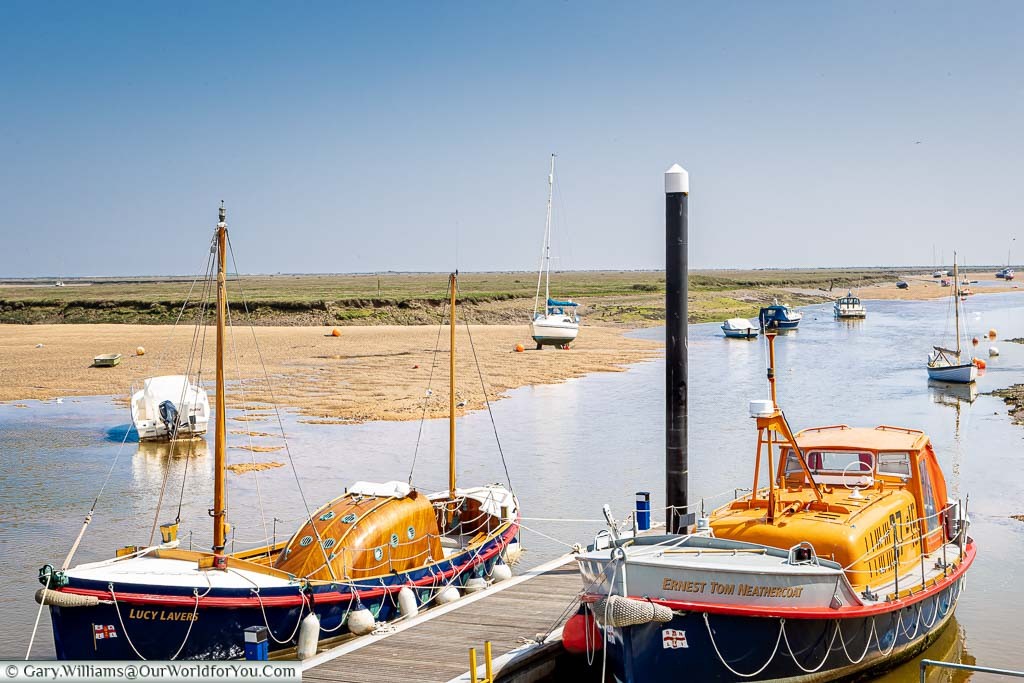 A pair of historic Lifeboats moored up at Wells-next-the-Sea on the North Norfolk coastline