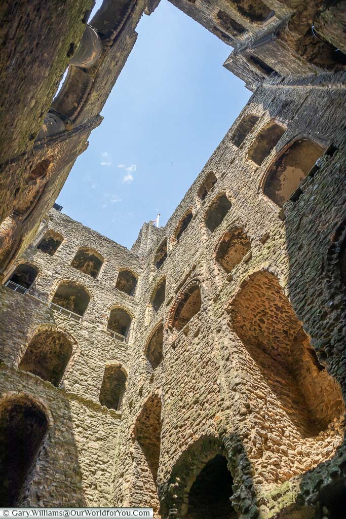 Looking up from the inside of the ruins of Rochester Castle to a bright blue sky
