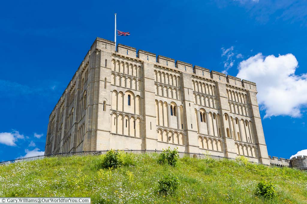Looking up at the very angular Norwich Castle under a deep blue sky