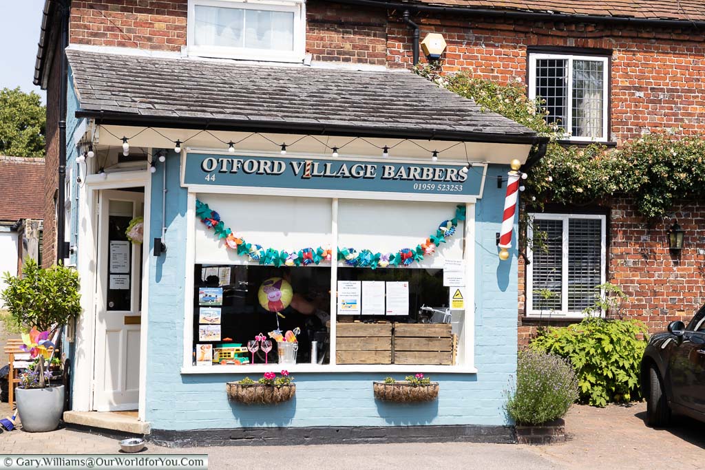 The quaint little powder blue Otford village Barbers shop