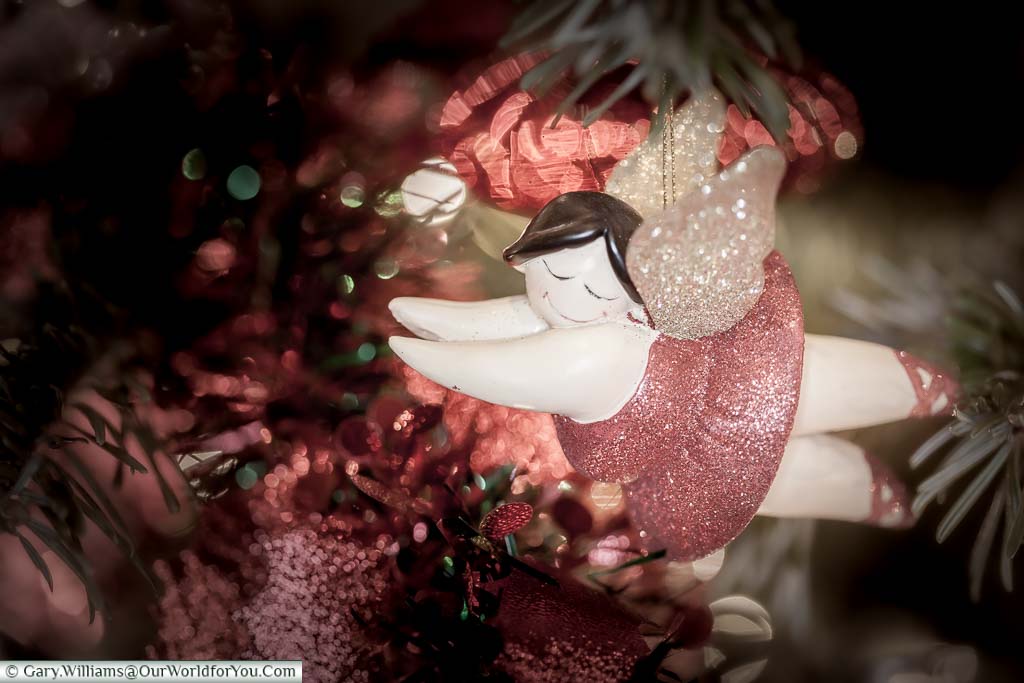 A close-up of a flying red fairy Christmas decoration on our tree