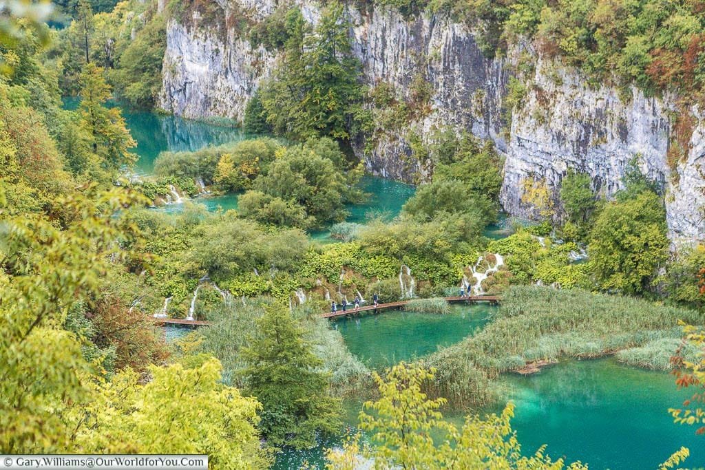 Looking down on numerous pools, nestled in chalk ravine, linked by walkways, as they flow down the valley creating multiple waterfalls.