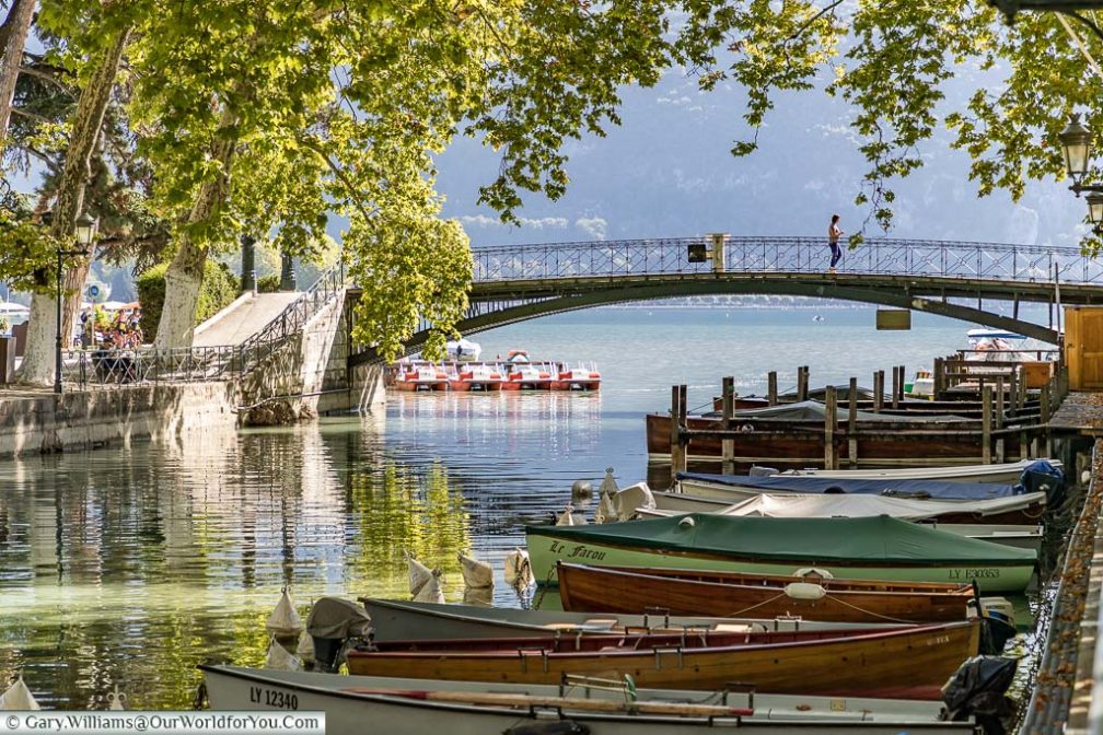 Wooden rowing boats linned up in the Canal du Vasse in Annecy, France