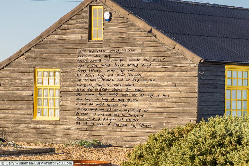 Part of John Donne’s poem, “The Sun Rising” in raised lettering on the side of Prospect Cottage on Dungeness Beach