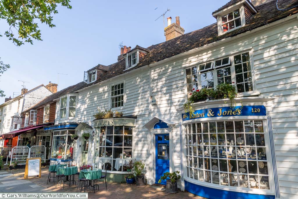 A selection of antique shops and tea houses line the old High Street in period buildings. Tables and chairs line the streets while antiques and bric-a-brac fill the windows.