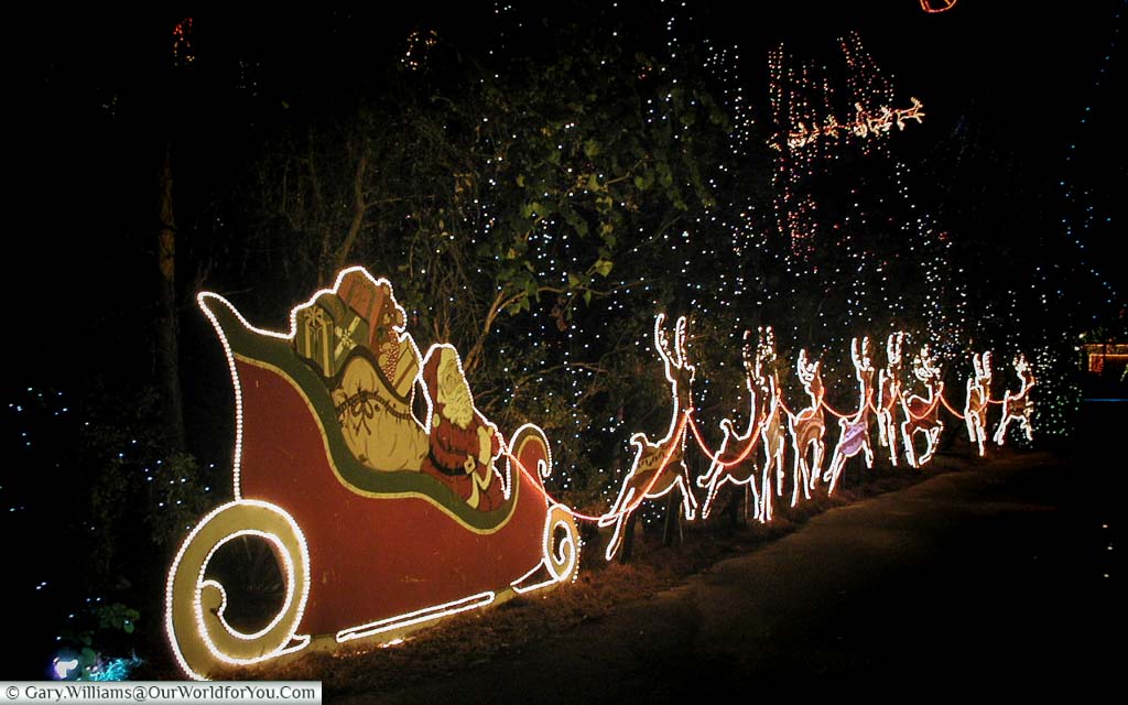 An illuminated Santa, his sleigh, and reindeers