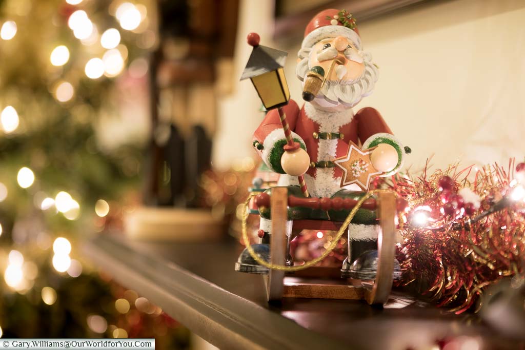 A German wooden Christmas decoration of Santa on his sleigh on our mantlepiece.