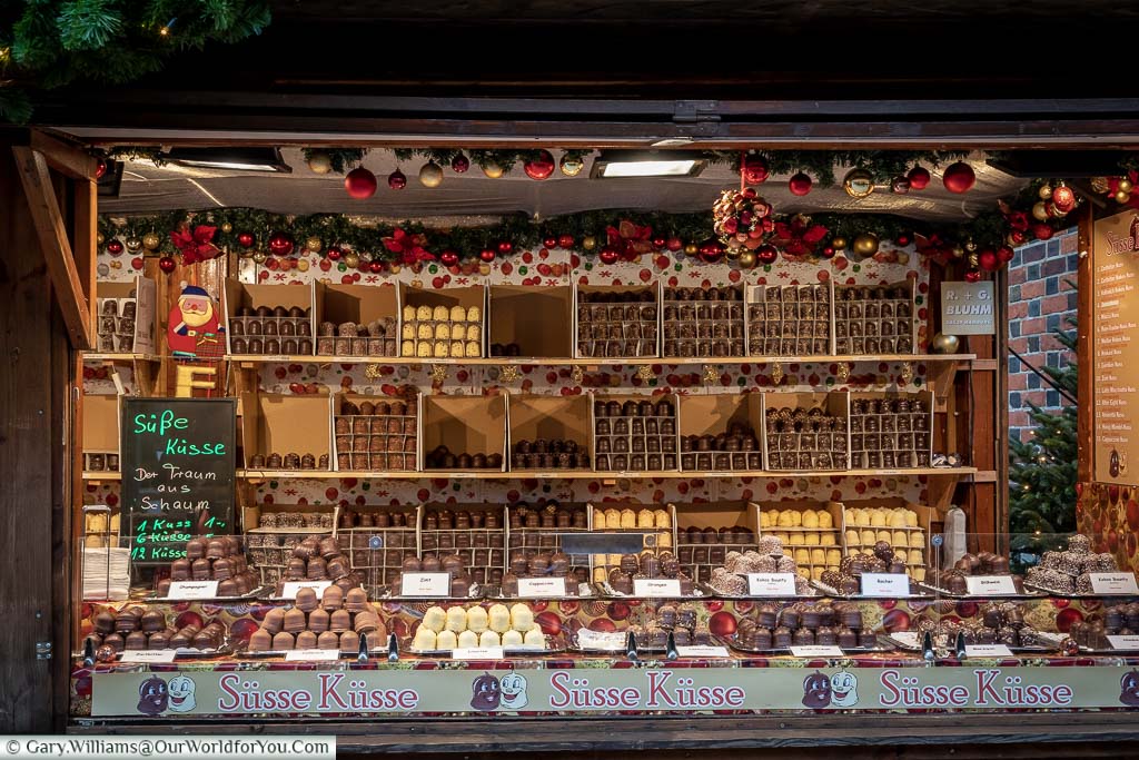 A Christmas market stall offering a large selection of Chocolate kisses in Hamburg