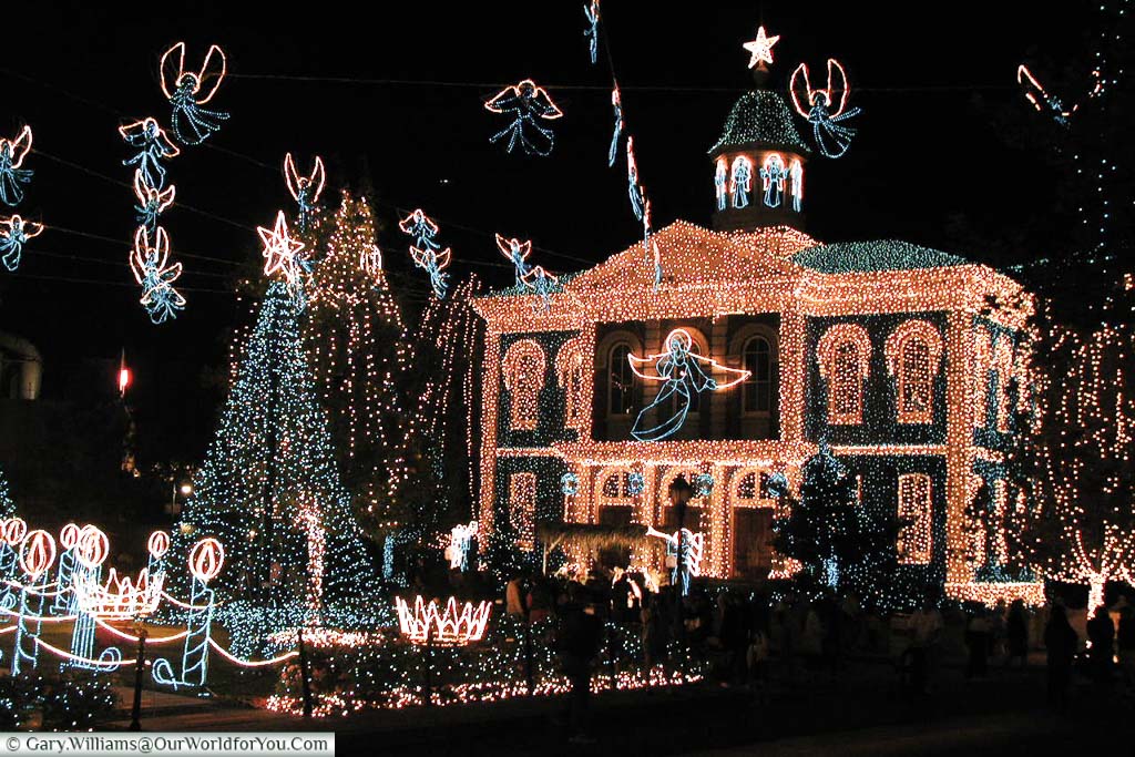 A fictional town hall at the MGM studios in Florida illuminated with fairy lights as part of the Osborne Family Christmas