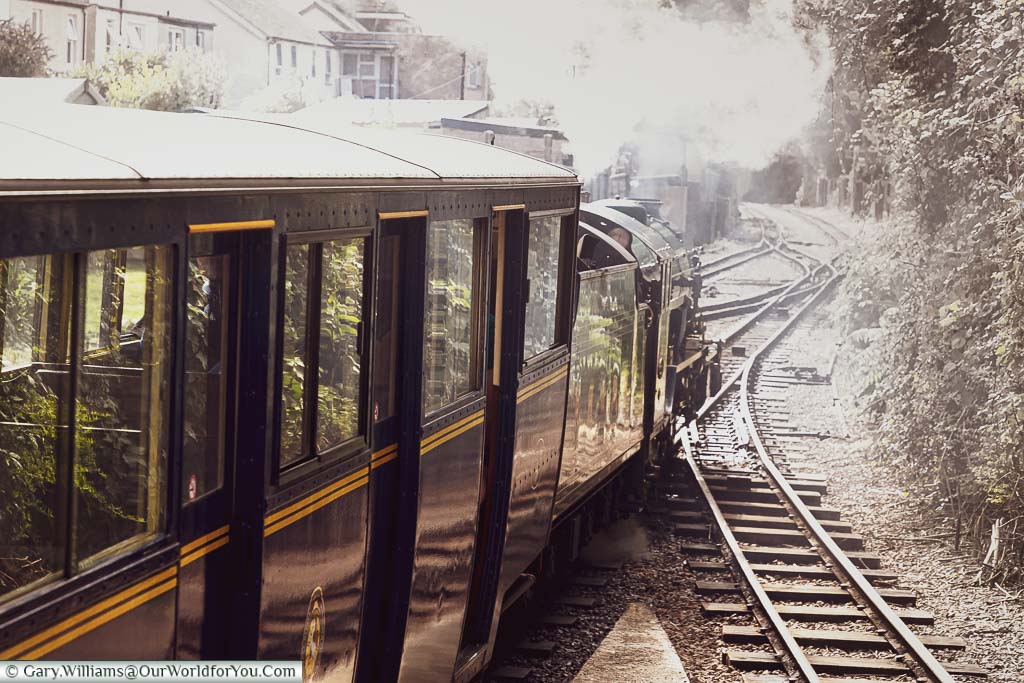A miniature steam engine from the Romney, Hythe & Dymchurch Railway leaving the platform.