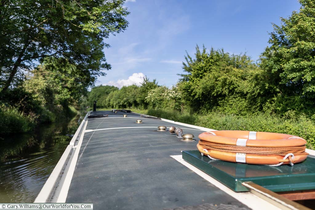 The view along the roof of our Widebeam canal boat with the lifebuoy, one of the many safety features onboard, located on the hatch at the aft end of the boat.
