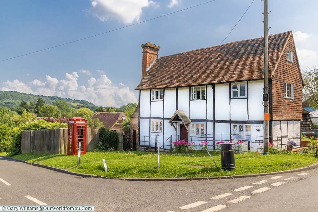 The 16th or 17th-century old forge building at Shoreham, now a home, with a red telephone box in the garden over looking the Darenth Valley