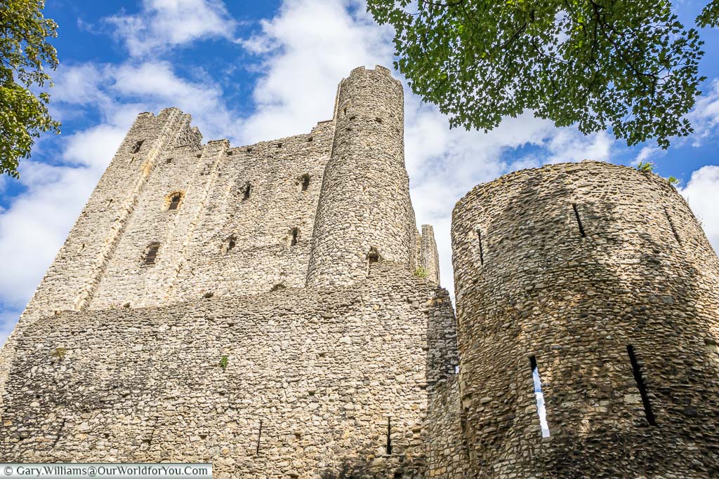 Looking up to the southern edge of Rochester castle where you can see one square tower and one round tower