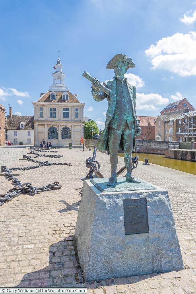 A bronze statue to the 18th Century Captain George Vancouver placed on the quayside, in front of Customs House in King's Lynn, Norfolk
