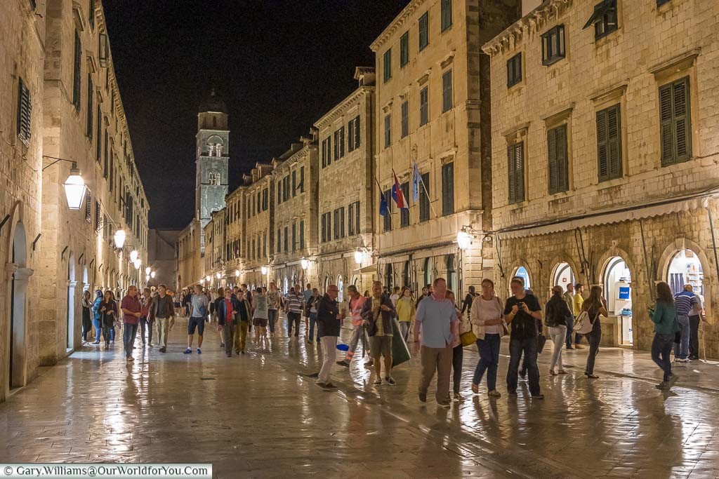 The stone-lined streets of Dubrovnik after dark, full with tourists