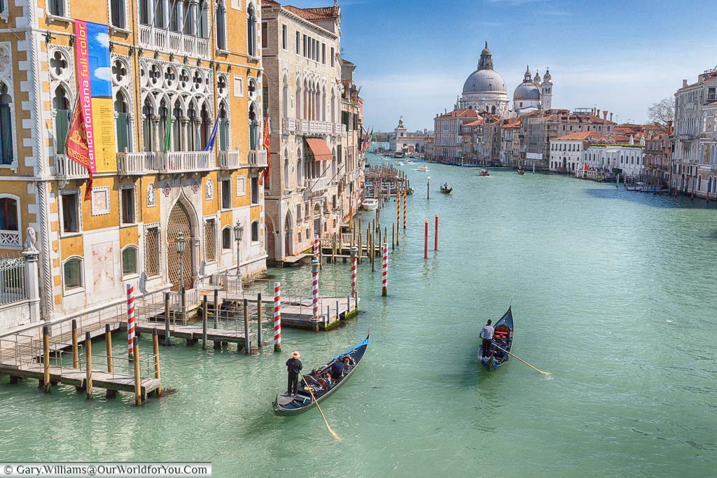The view along the Grand Canal in Venice, complete with gondoliers, towards the Basilica di Santa Maria della Salute from Ponte dell'Accademia
