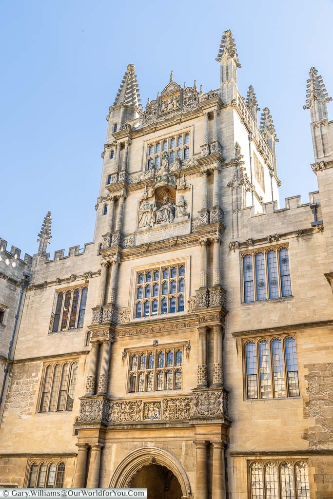 The golden stonework of the ornately decorated Tower of the Five Orders entrance to Bodleian Library in Oxford