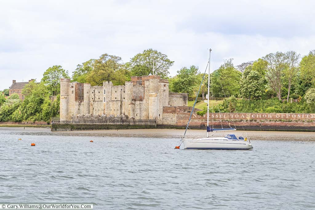 A view across the choppy River Medway, in Kent, to Upnor Castle on the far bank. A small sailing boat is anchored in the centre of the River