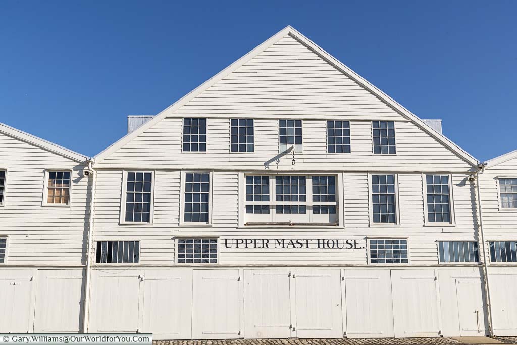 The white weatherboarded Upper Mast House against a deep blue sky at the Historic Dockyard Chatham