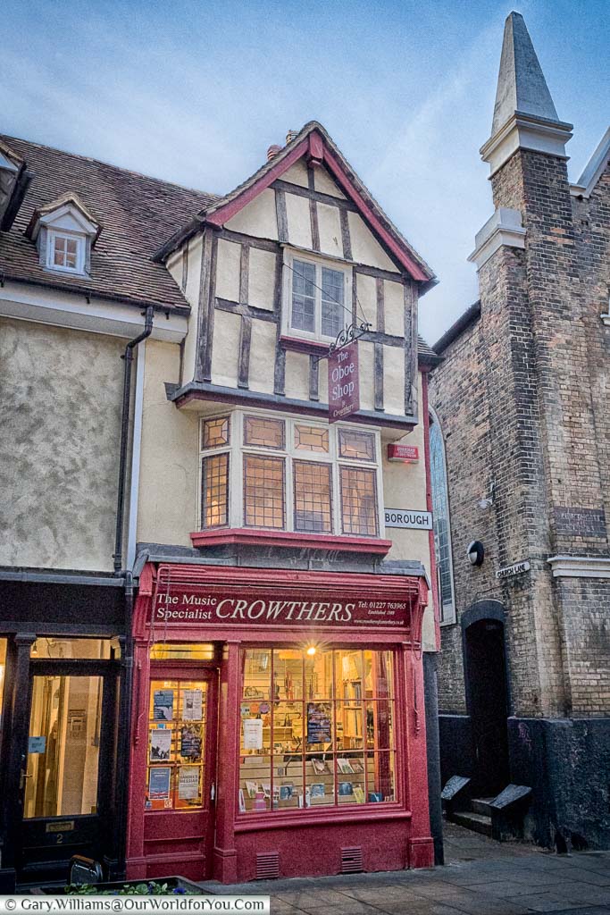 A shop with a red frontage in a historic building on the King's Mile in Canterbury