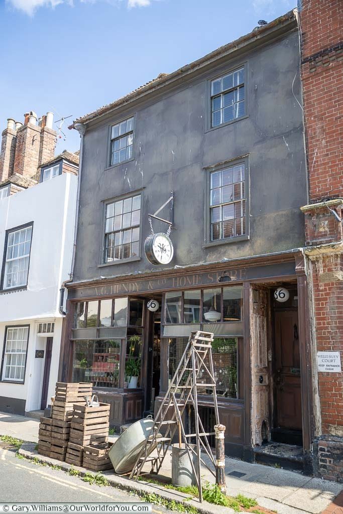 A traditional old hardware store on Hastings High Street with a selection of good on the pavement outside.